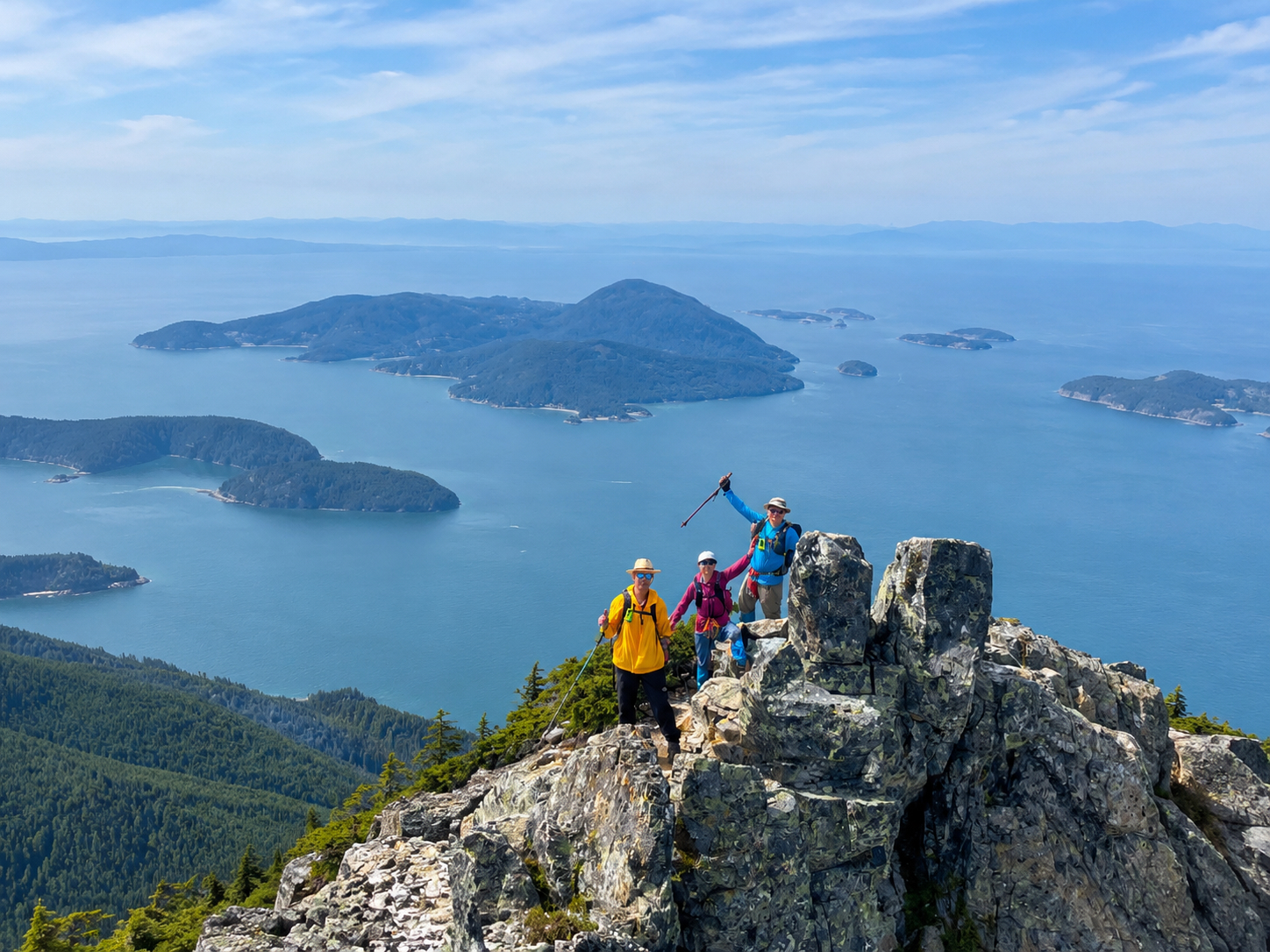 Patrick, Helen, and Victor posing with island archipelago background
