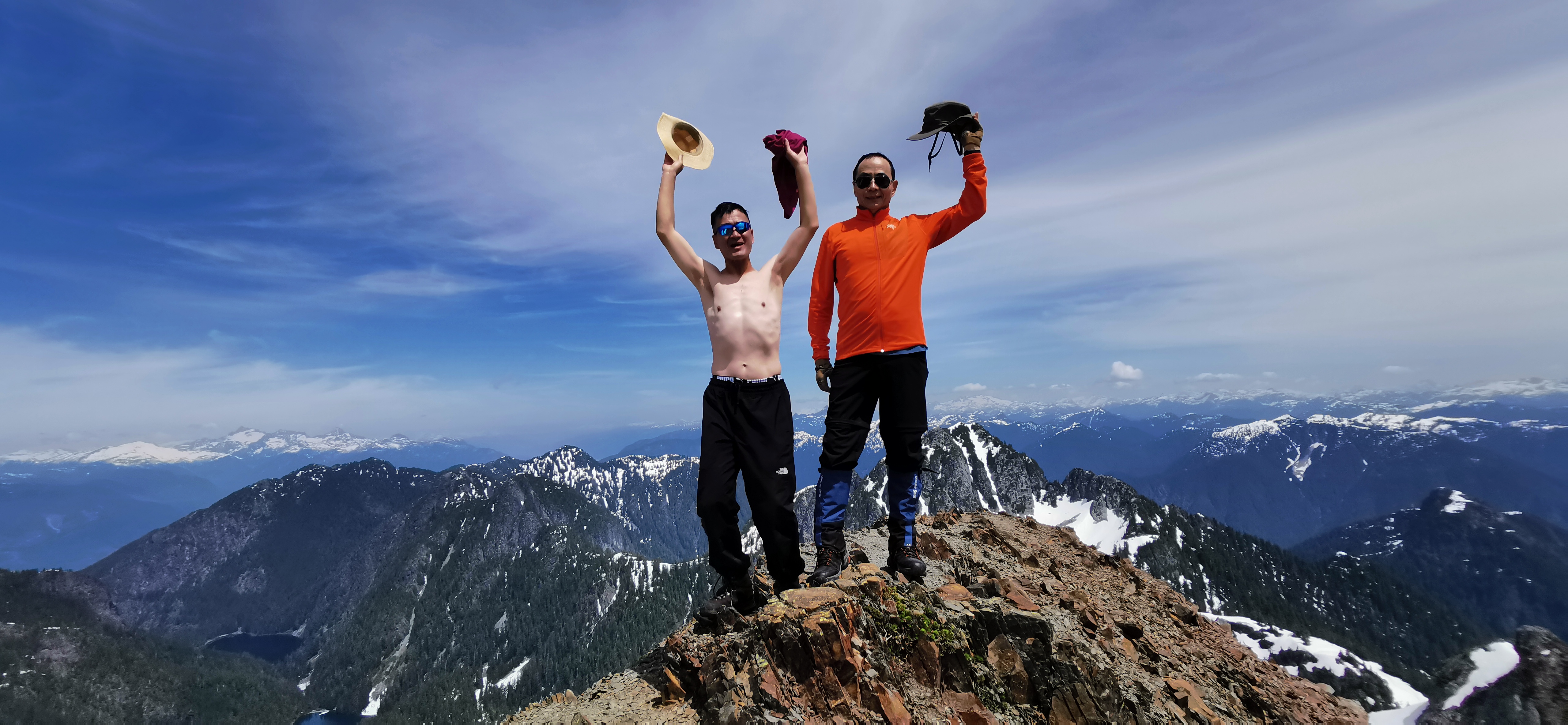 Patrick and Qiqi celebrating with scenic mountain vistas in the background