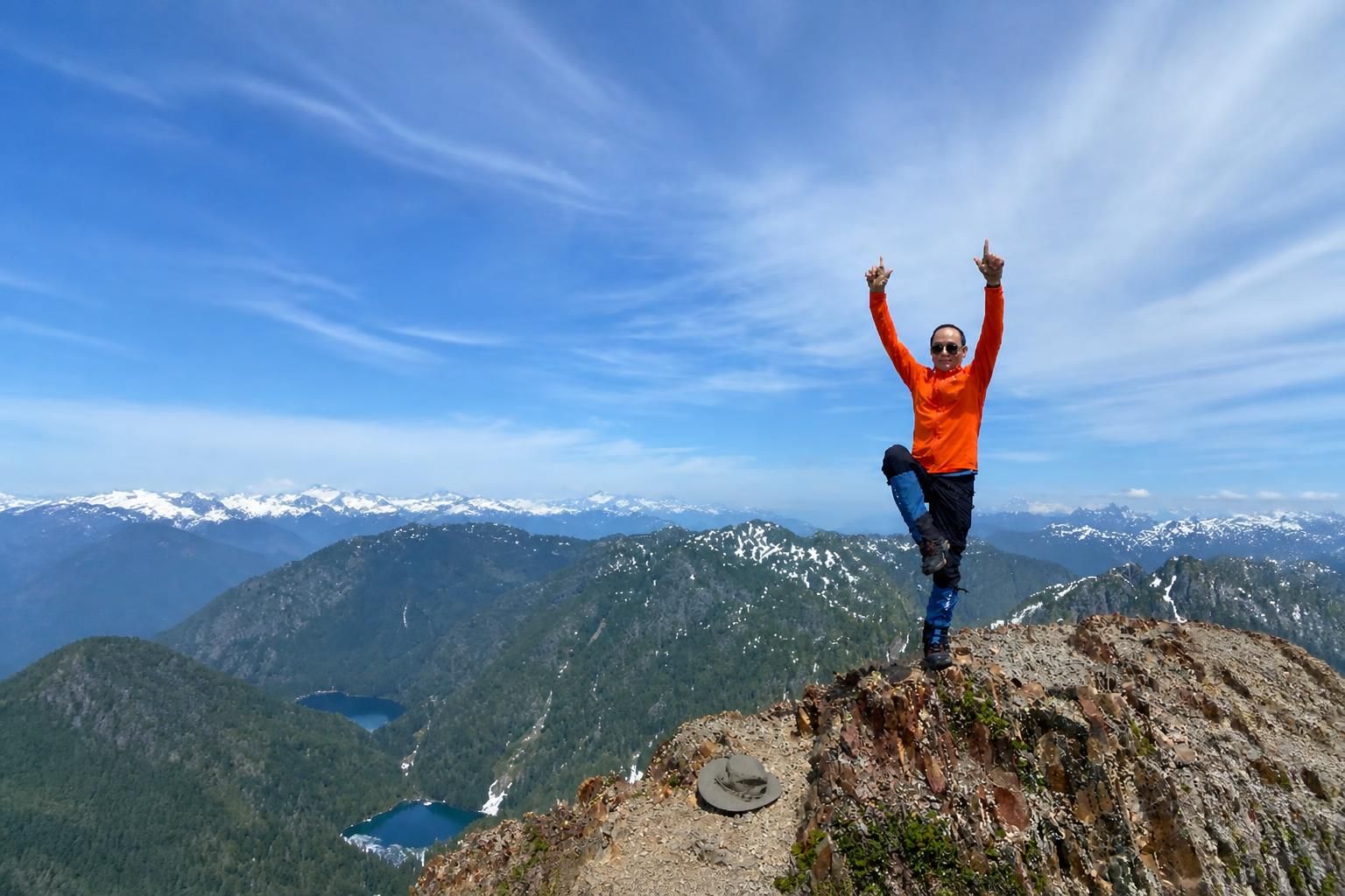 Qiqi performing a Golden Rooster pose on one leg at the summit