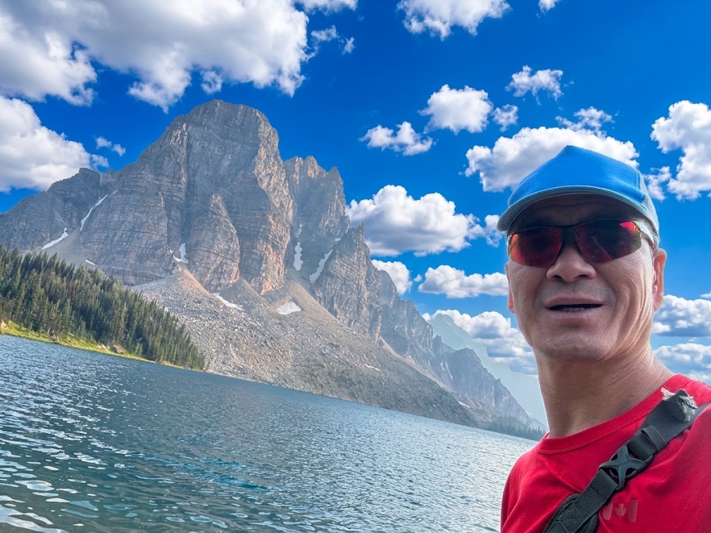 Patrick at Cerulean Lake with Sunburst Peak background
