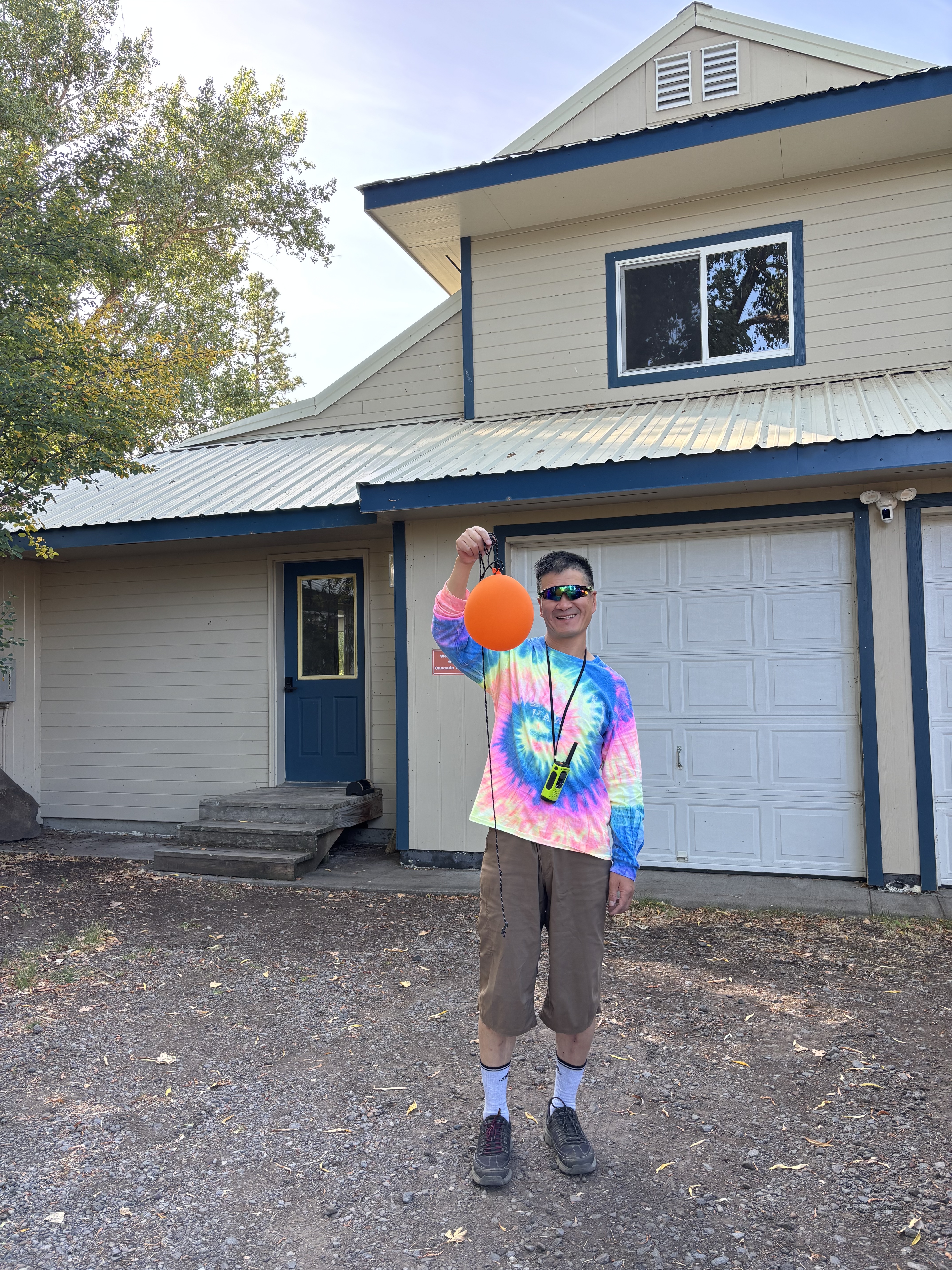 Patrick holding an orange balloon as a cheerful gesture of apology